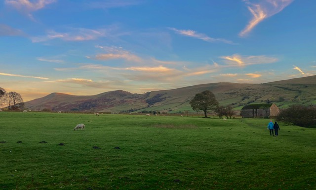 Evening walk across the fields with scenic views of the surrounding hills.