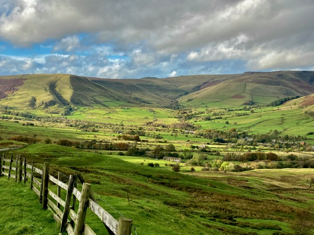 Beautiful panoramic view of the Edale valley, showcasing the lush green fields and surrounding hills.